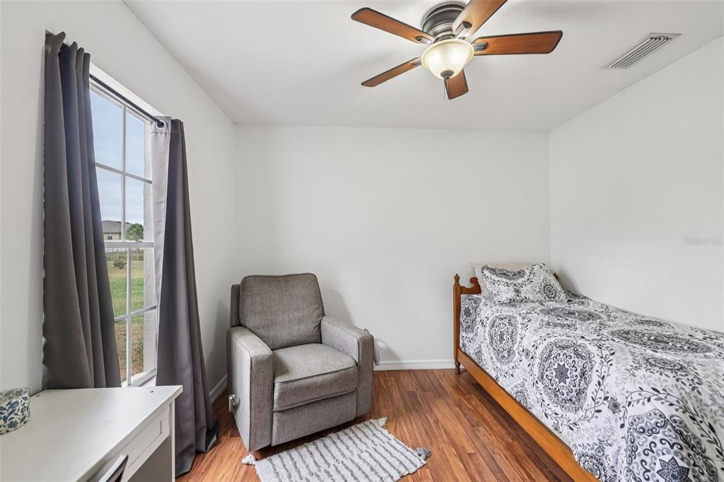 12315 Fort King Road Dade City, FL 33525 - Photo 34 of 77 a bedroom with furniture and a window