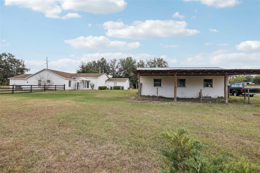 12315 Fort King Road Dade City, FL 33525 - Photo 58 of 77 a view of a house with a backyard