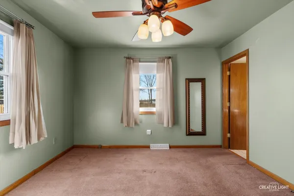 a view of a big room with a chandelier fan