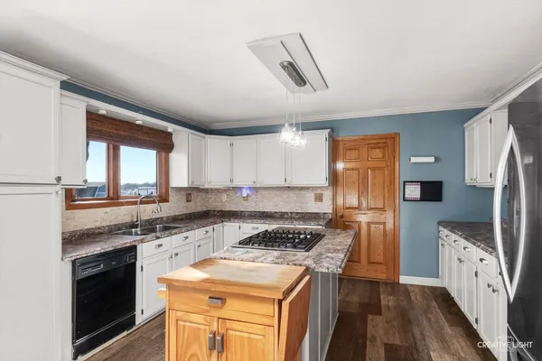 a kitchen with a stove a sink and a refrigerator