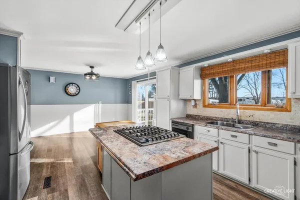 a kitchen with a sink stove and cabinets