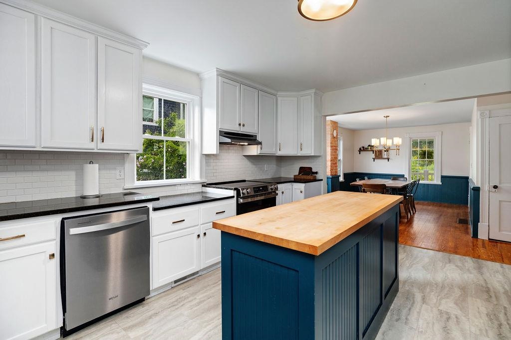 7549 Thomas Spring Road Bridgewater, VA 22812 - Photo 35 of 57 a kitchen with stainless steel appliances granite countertop a sink dishwasher stove and white cabinets with wooden floor