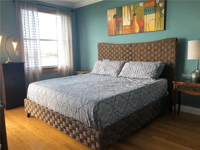 a bedroom with a bed and a mirror