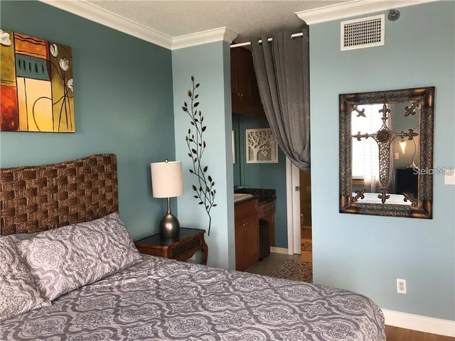 a bedroom with a bed and a large window