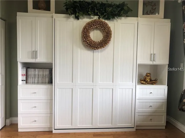 a kitchen with a wooden floor and white doors