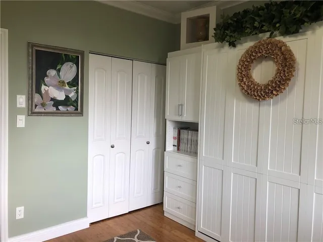 a view of a hallway with couches and painted walls