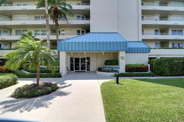 a front view of a house with garden and patio