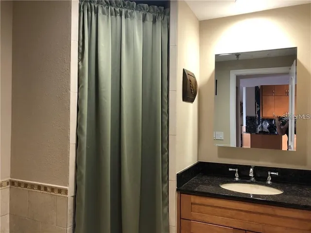 a view of a livingroom with wooden floor and a window