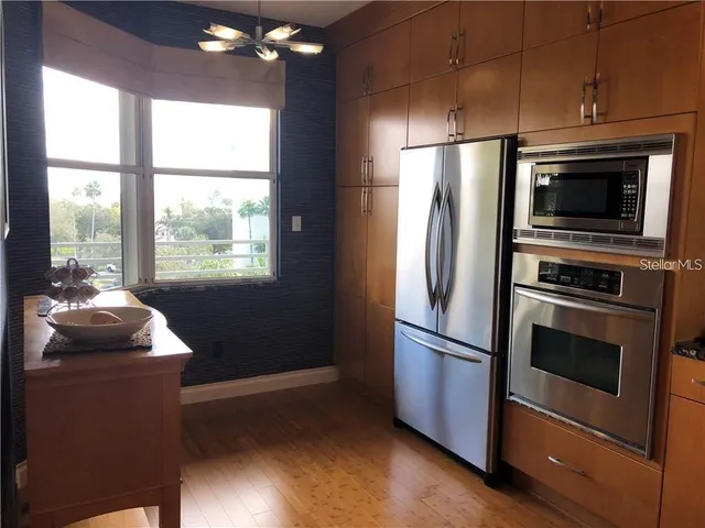 a kitchen with a refrigerator and a stove
