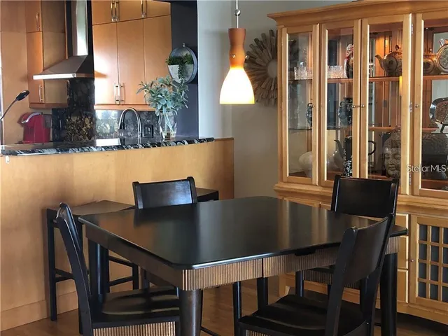 a view of a dining room with furniture and a potted plant