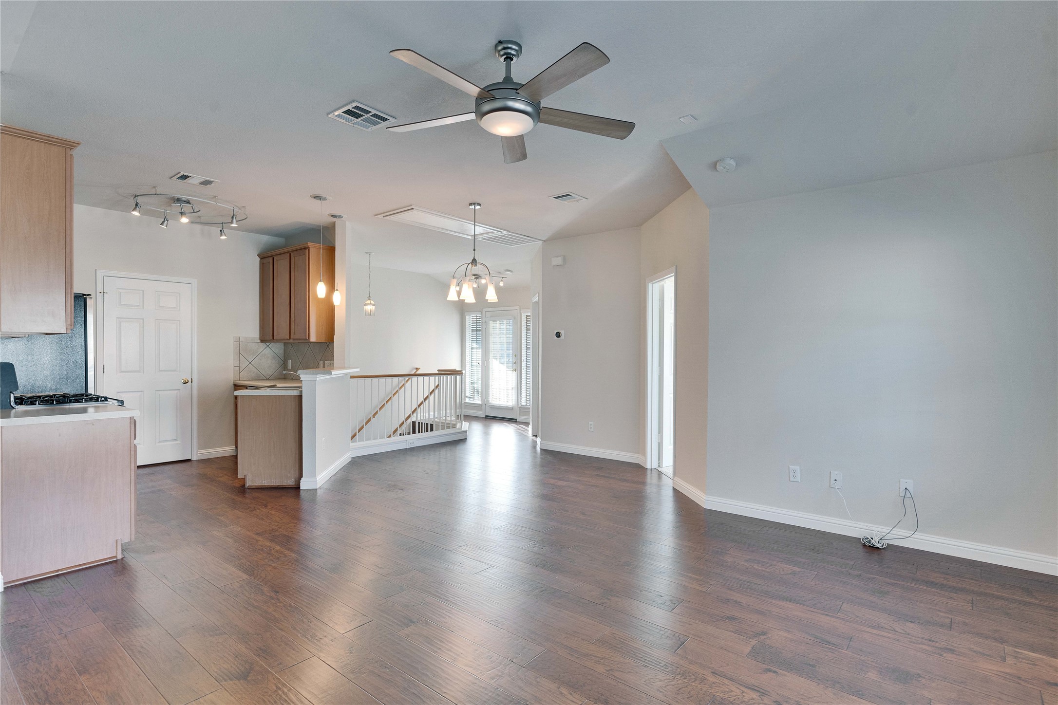 1900 Scofield Ridge Parkway, Unit 2701 Austin, TX 78727 - Photo 1 of 20 an empty room with wooden floor and a kitchen
