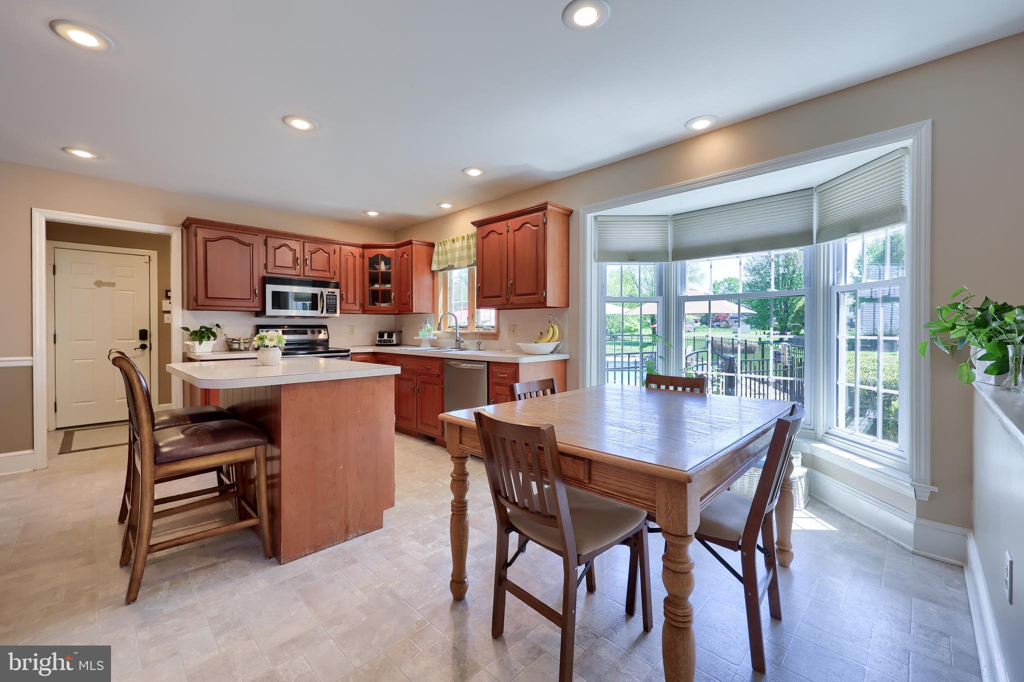 105 Hammersmith Lane Lititz, PA 17543 - Photo 14 of 49 a dining room with stainless steel appliances a dining table and chairs