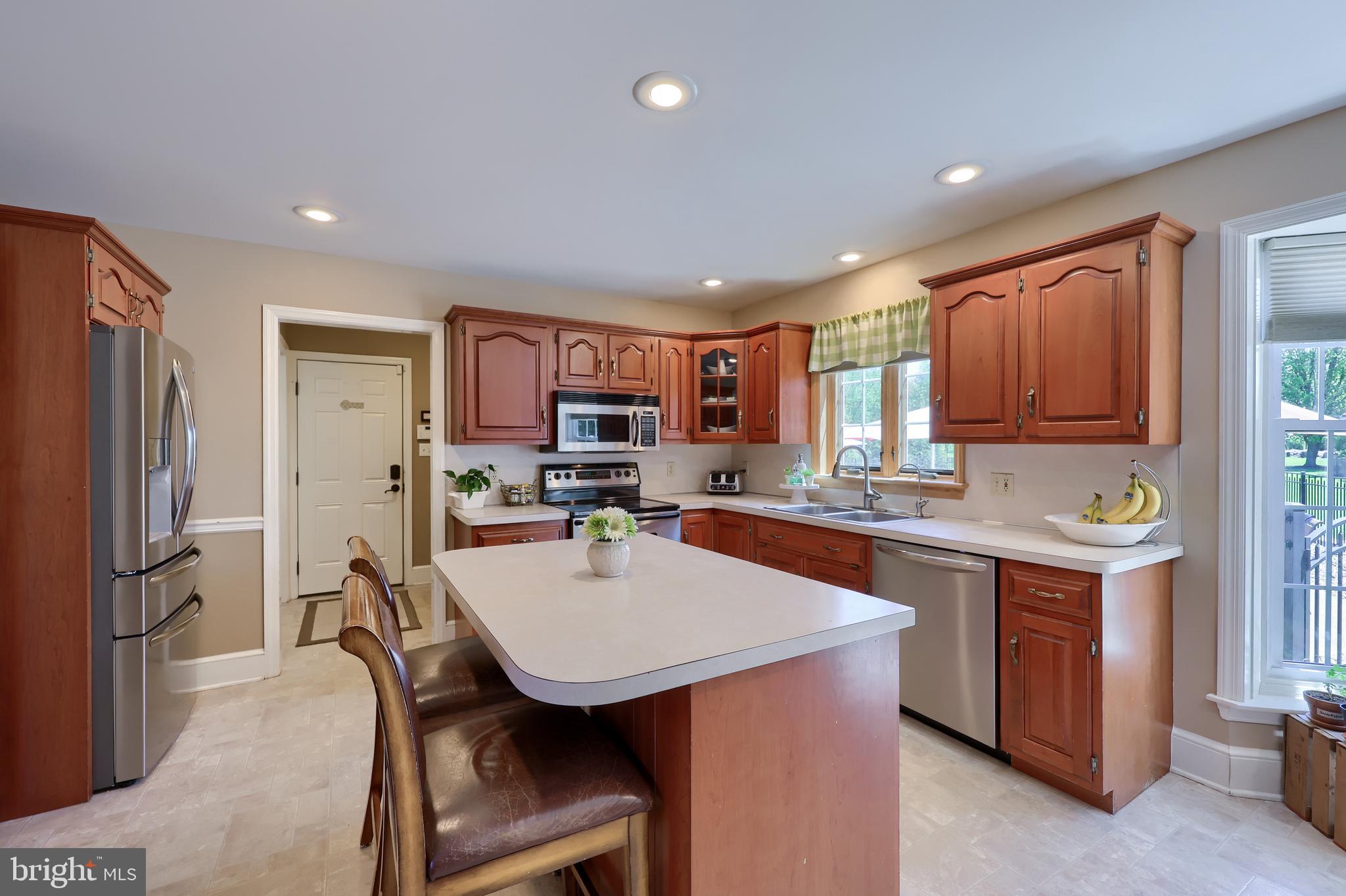 105 Hammersmith Lane Lititz, PA 17543 - Photo 16 of 49 a kitchen with a dining table chairs and refrigerator