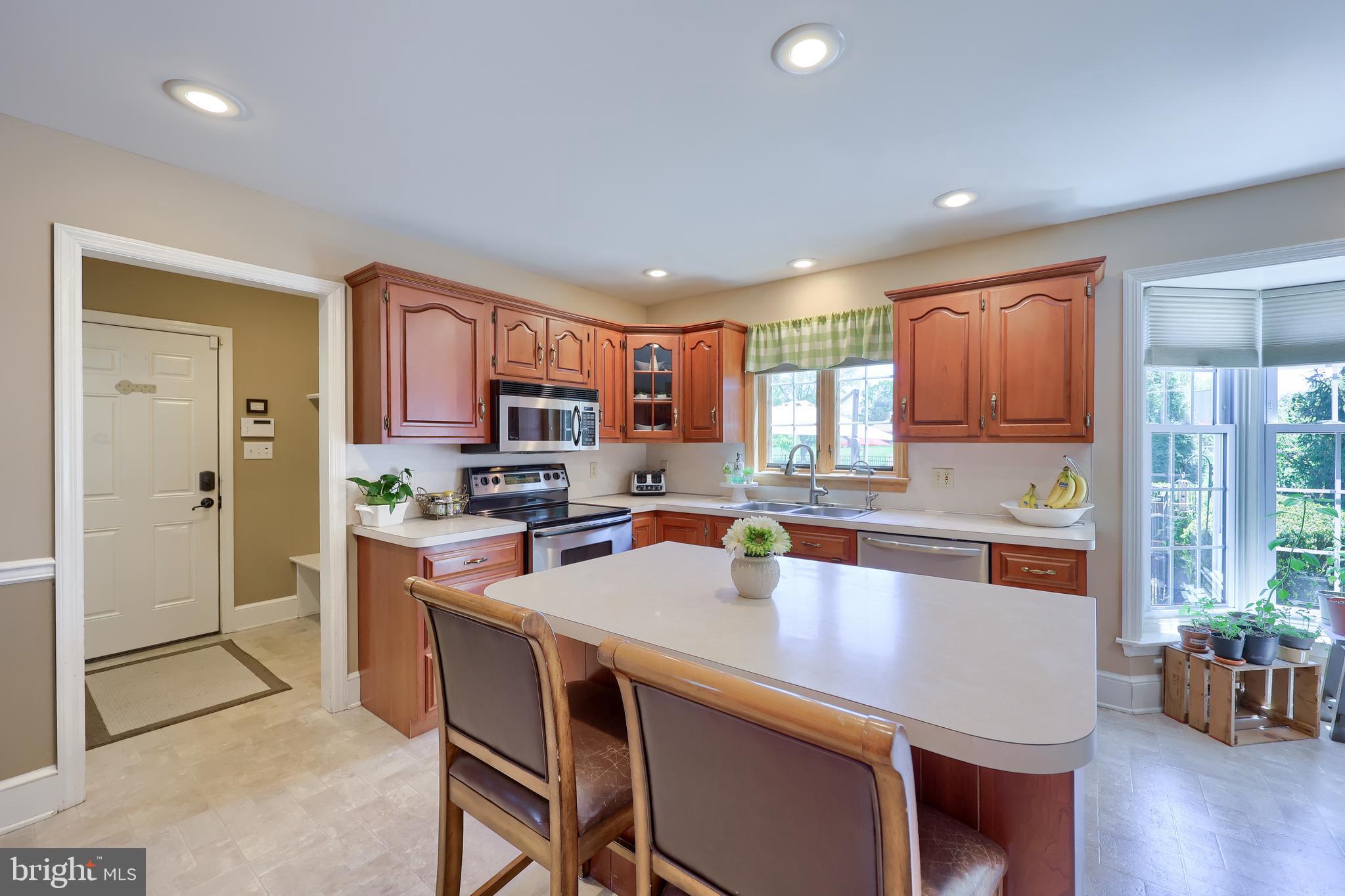 105 Hammersmith Lane Lititz, PA 17543 - Photo 17 of 49 a kitchen with a table chairs refrigerator and cabinets