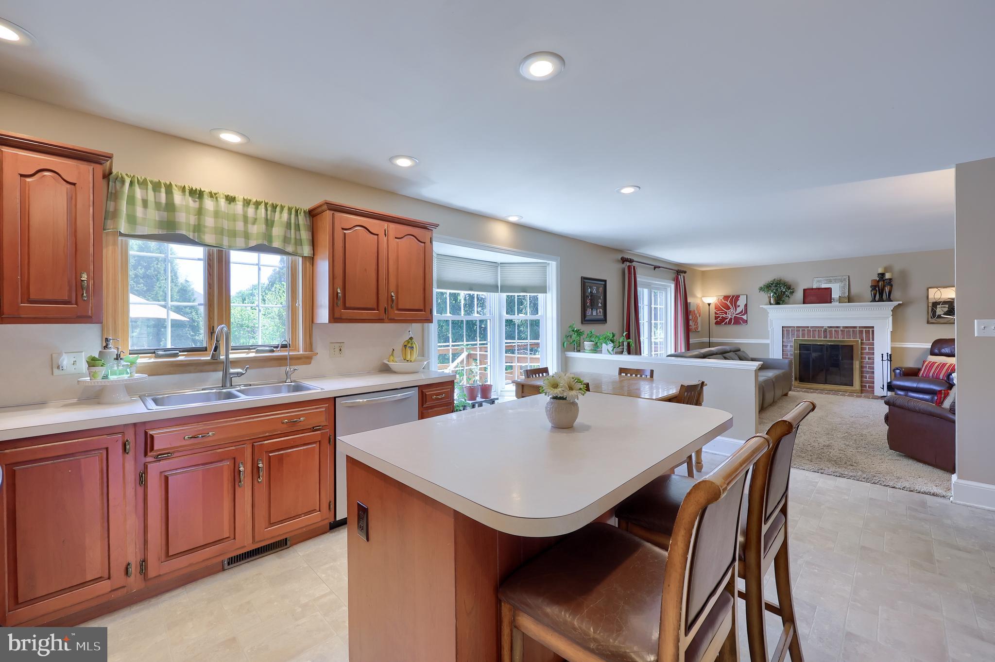 105 Hammersmith Lane Lititz, PA 17543 - Photo 18 of 49 a kitchen with a sink a stove a counter space and chairs