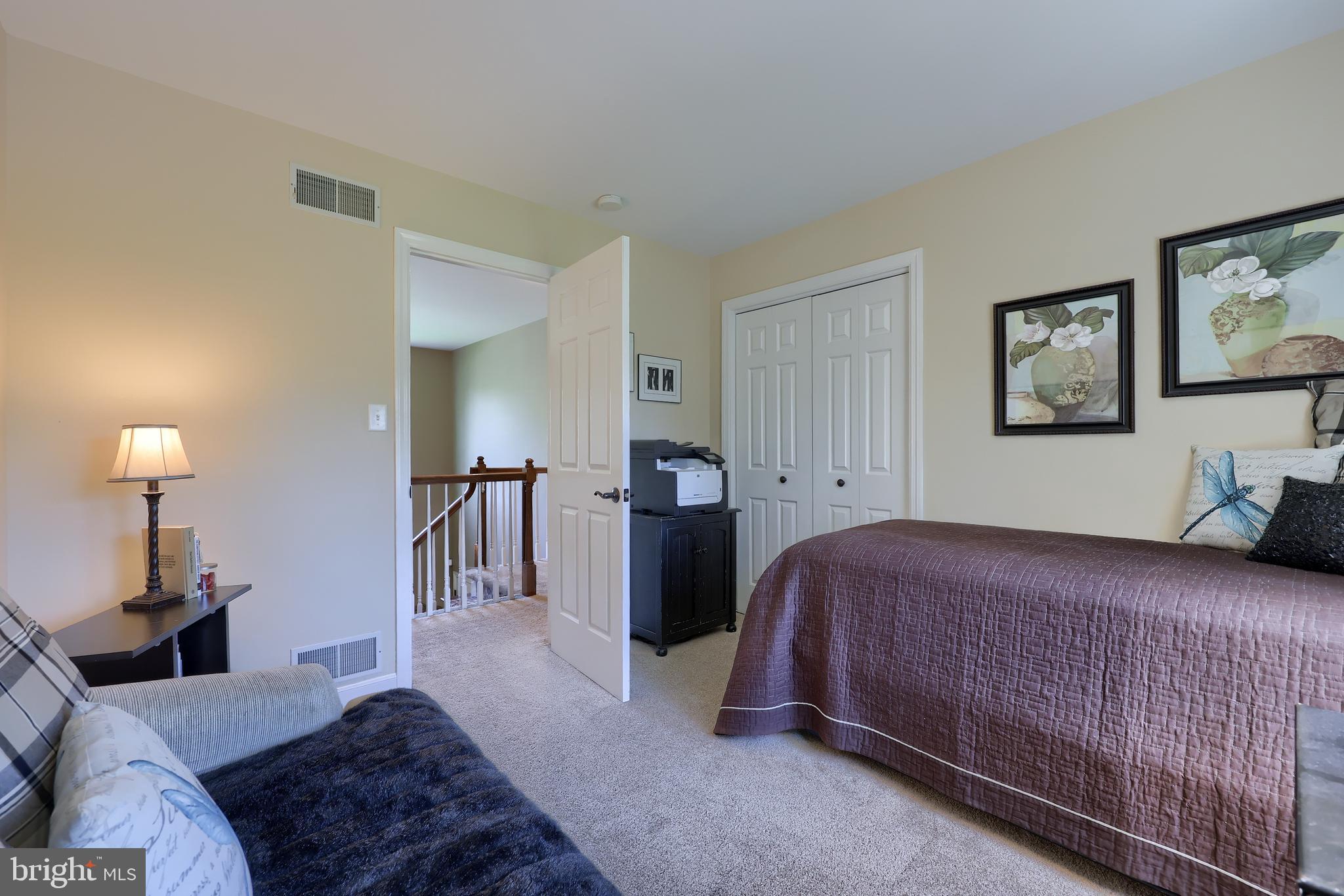 105 Hammersmith Lane Lititz, PA 17543 - Photo 35 of 49 a bedroom with a bed and a lamp