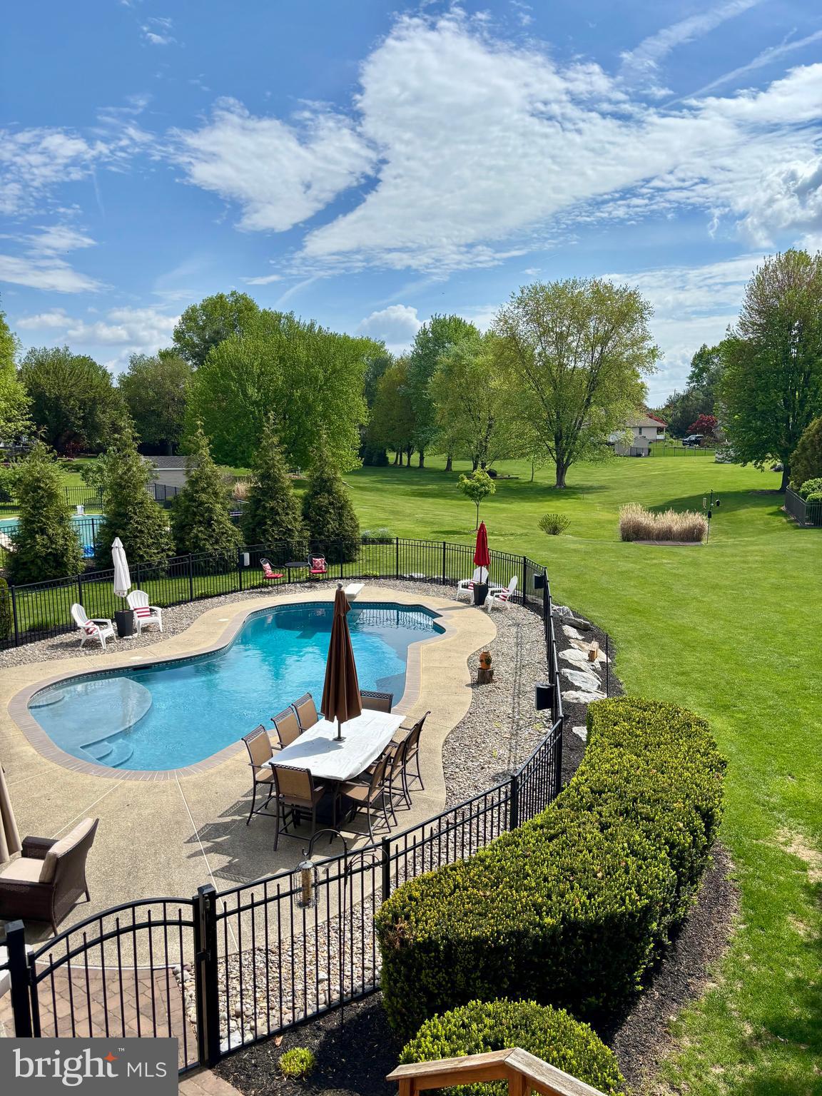 105 Hammersmith Lane Lititz, PA 17543 - Photo 38 of 49 a view of a swimming pool and lounge chairs in back of the house