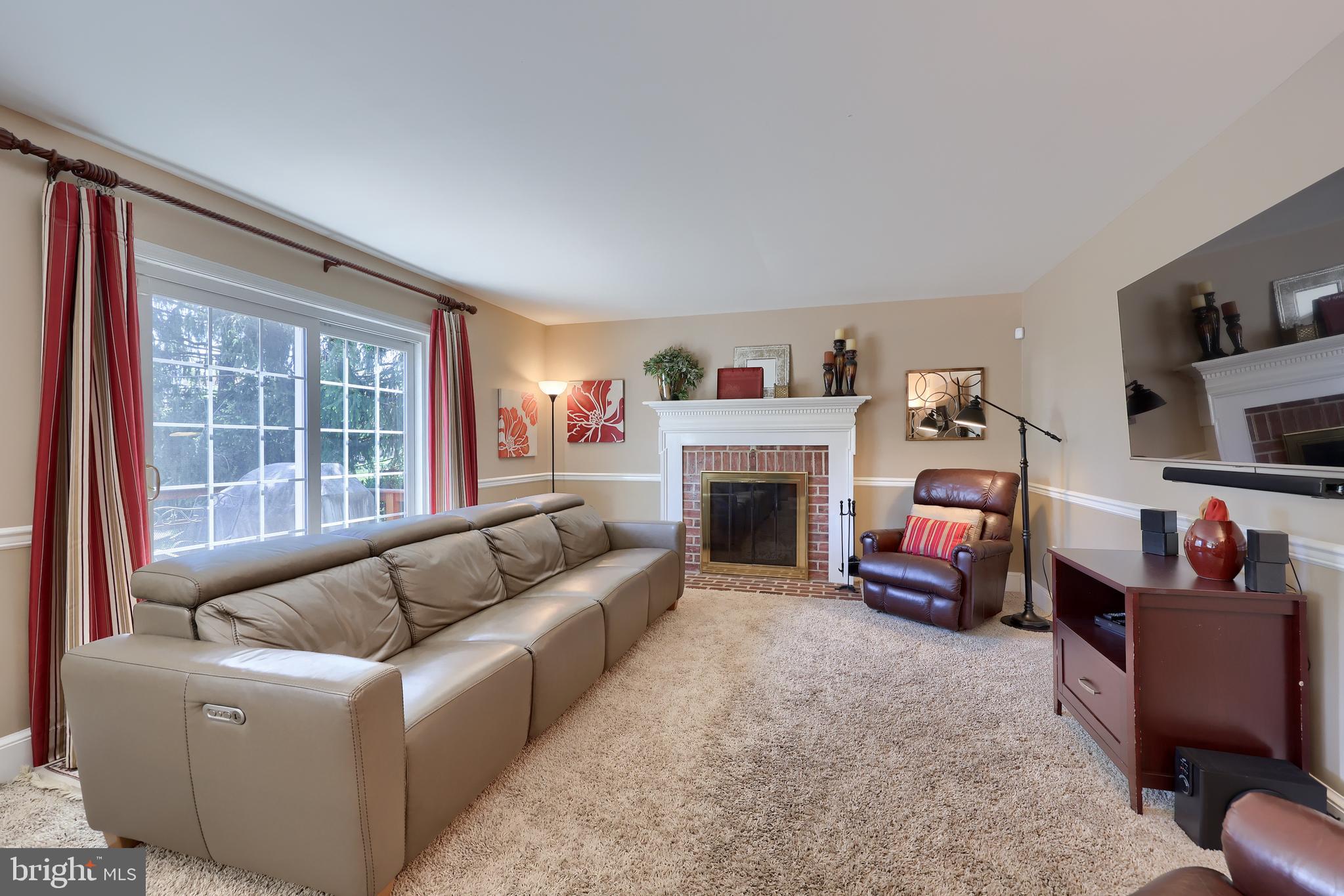 105 Hammersmith Lane Lititz, PA 17543 - Photo 10 of 49 a living room with furniture a fireplace and a large window