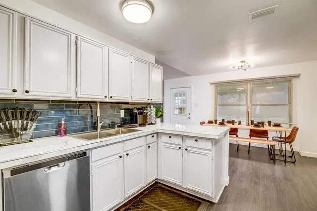 a kitchen with a sink and cabinets