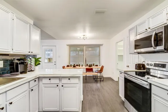 a kitchen with a sink stove and cabinets