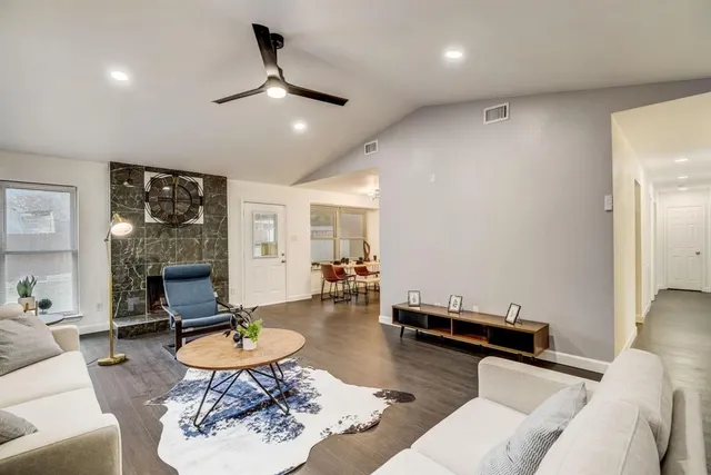 a living room with furniture and wooden floor