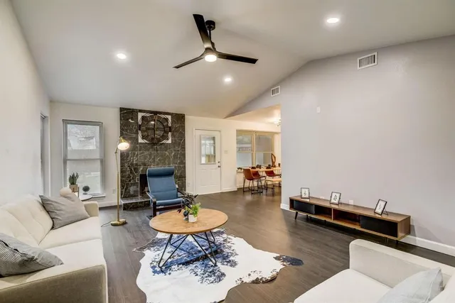 a living room with furniture a rug and a table