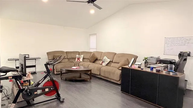 a living room with furniture a air conditioner and a window
