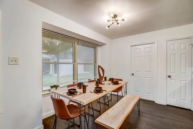 a view of a dining room with furniture a chandelier and wooden floor