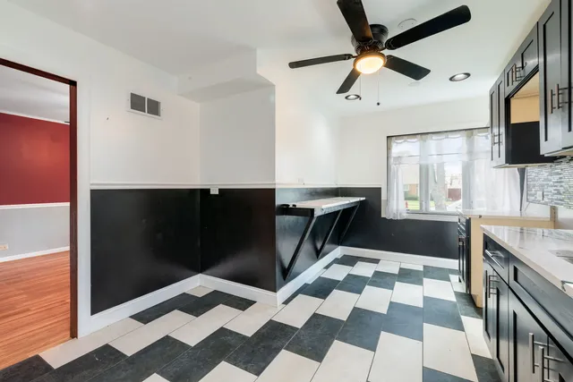 a kitchen with a checkered floor and a refrigerator