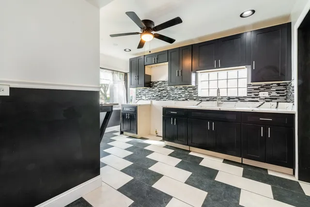 a kitchen with stainless steel appliances granite countertop a refrigerator a sink and dishwasher