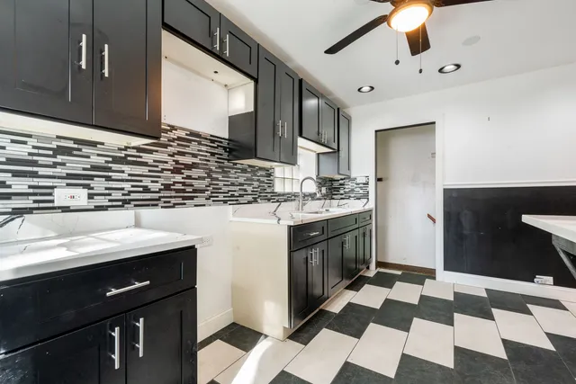 a kitchen with a sink stove and cabinets