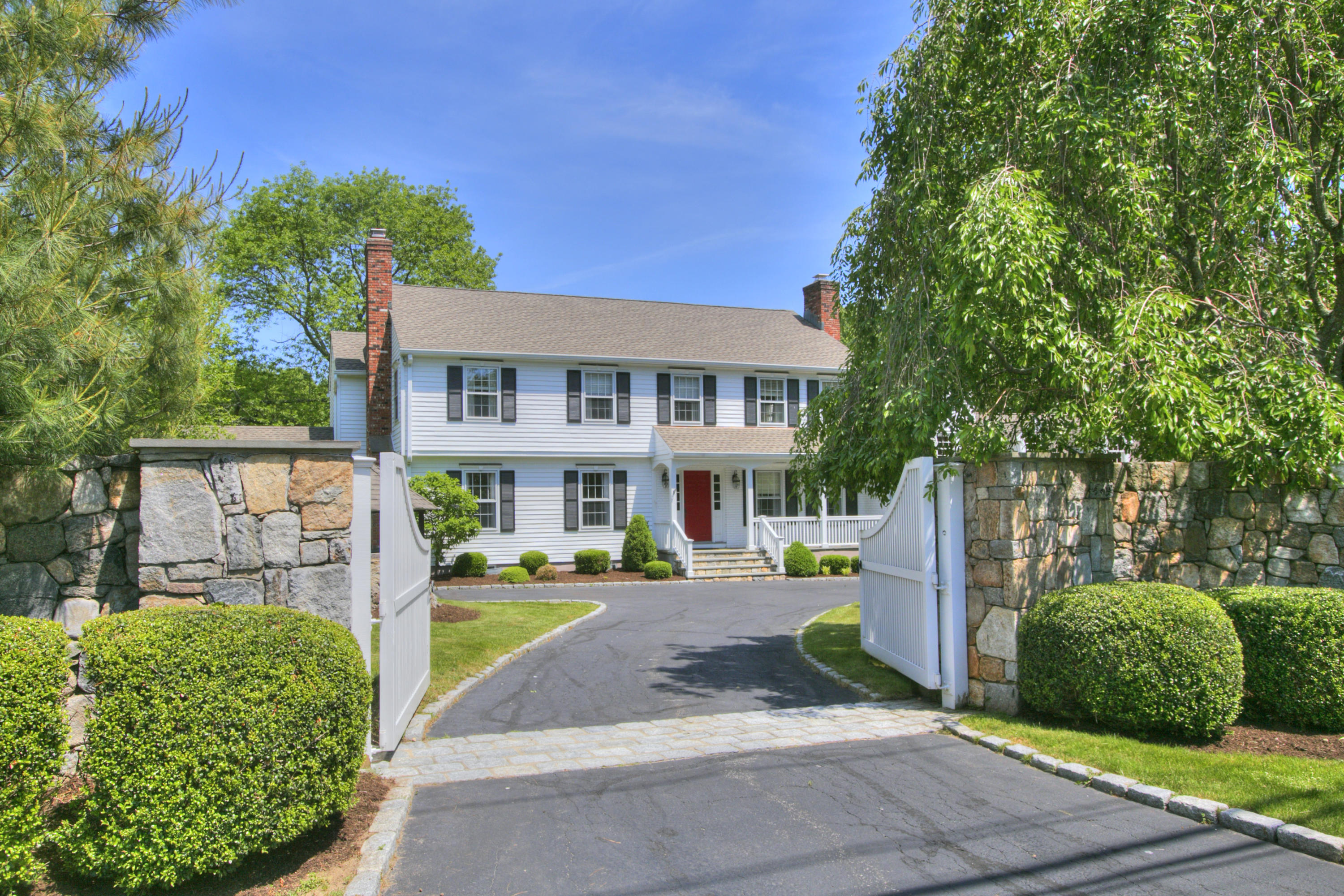195 Ponus Ridge Road New Canaan, CT 06840 - Photo 1 of 28 a front view of a house with a yard
