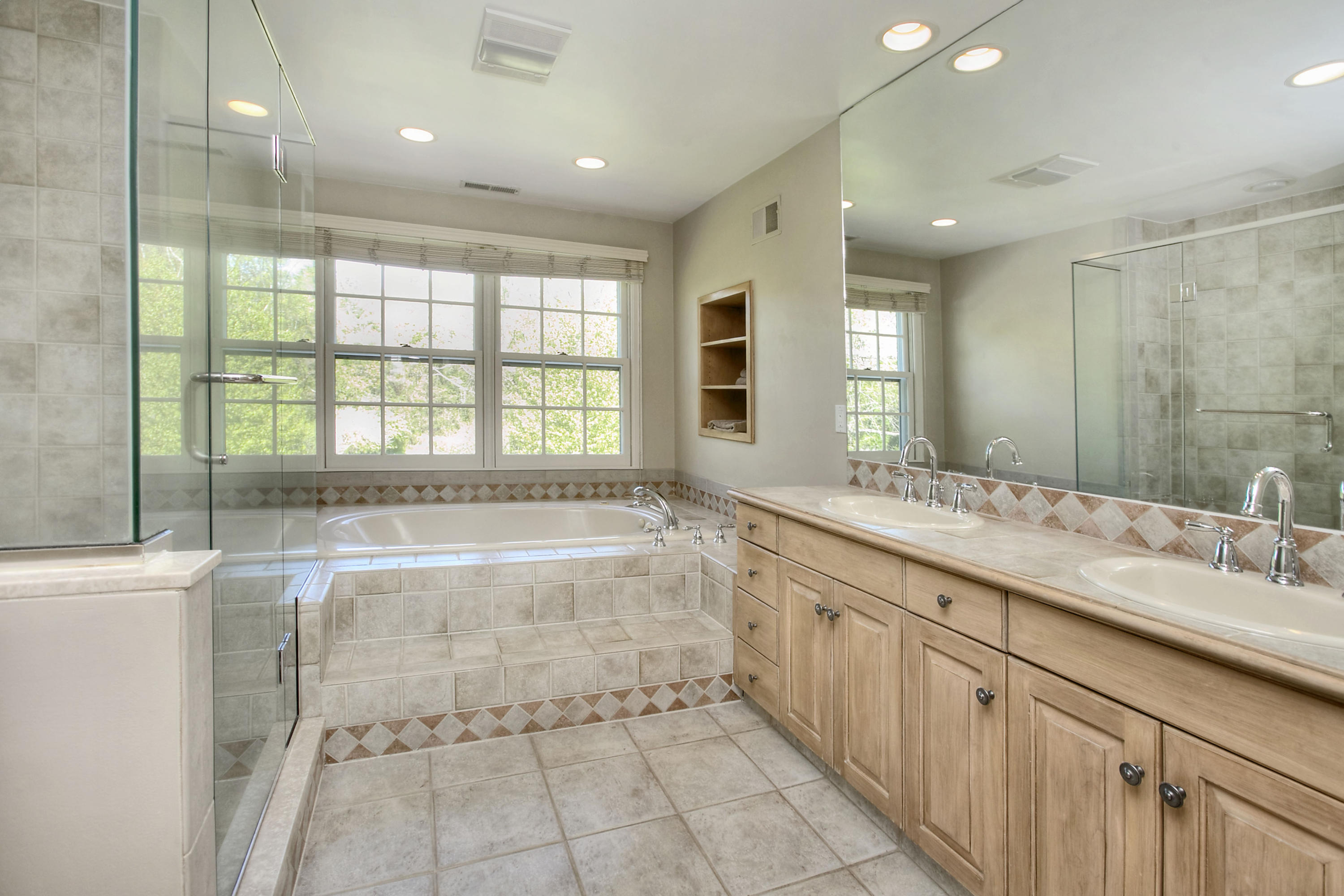 195 Ponus Ridge Road New Canaan, CT 06840 - Photo 15 of 28 a spacious bathroom with a double vanity sink a large mirror and shower