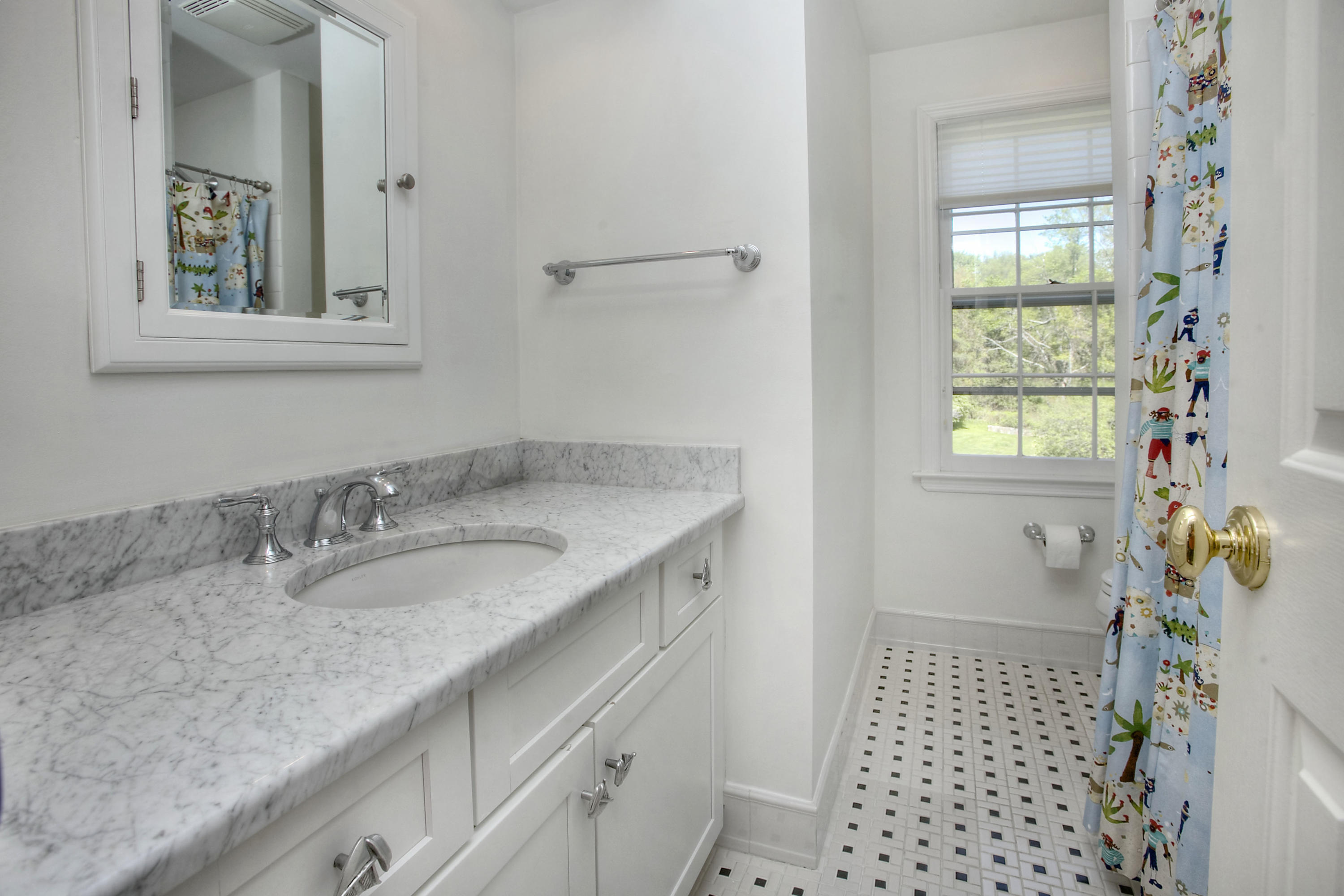 195 Ponus Ridge Road New Canaan, CT 06840 - Photo 17 of 28 a bathroom with a granite countertop sink a vanity and a window