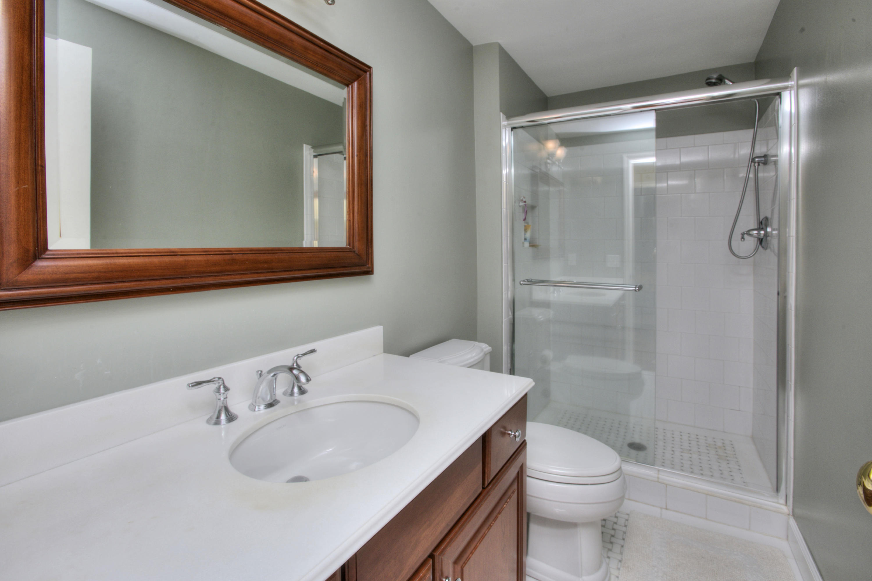 195 Ponus Ridge Road New Canaan, CT 06840 - Photo 19 of 28 a bathroom with a sink toilet and shower