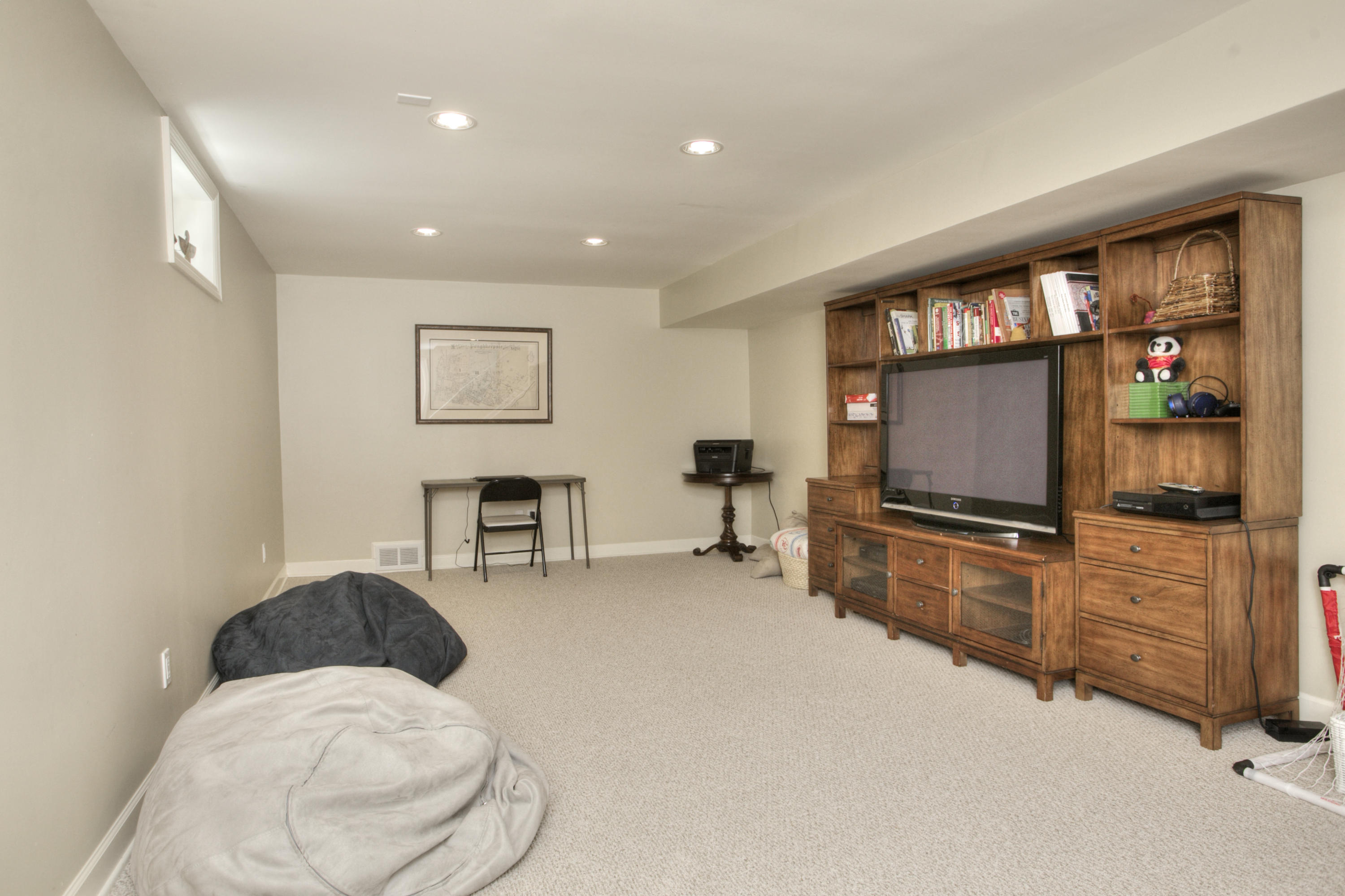 195 Ponus Ridge Road New Canaan, CT 06840 - Photo 20 of 28 a living room with furniture and a flat screen tv