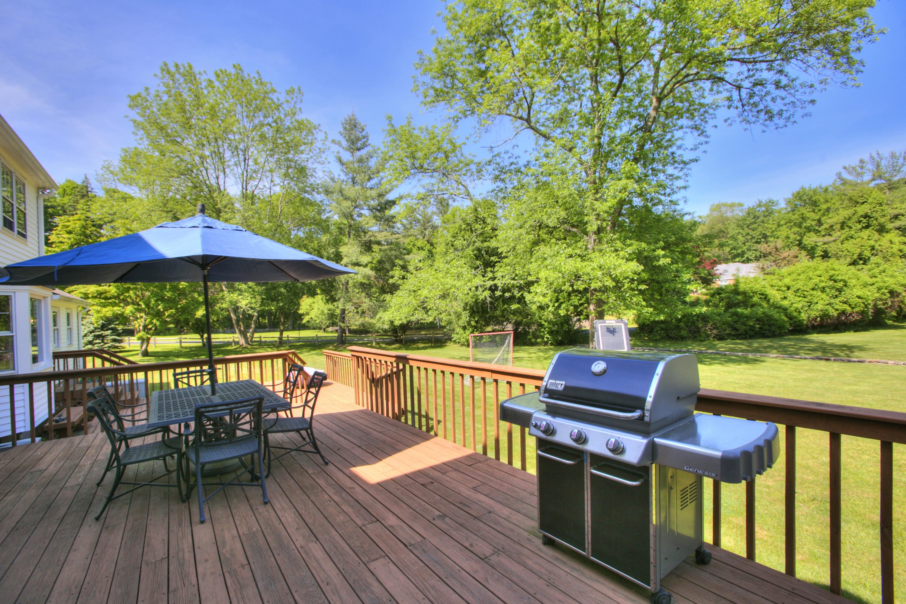 195 Ponus Ridge Road New Canaan, CT 06840 - Photo 23 of 28 an outdoor sitting area with furniture and wooden floor