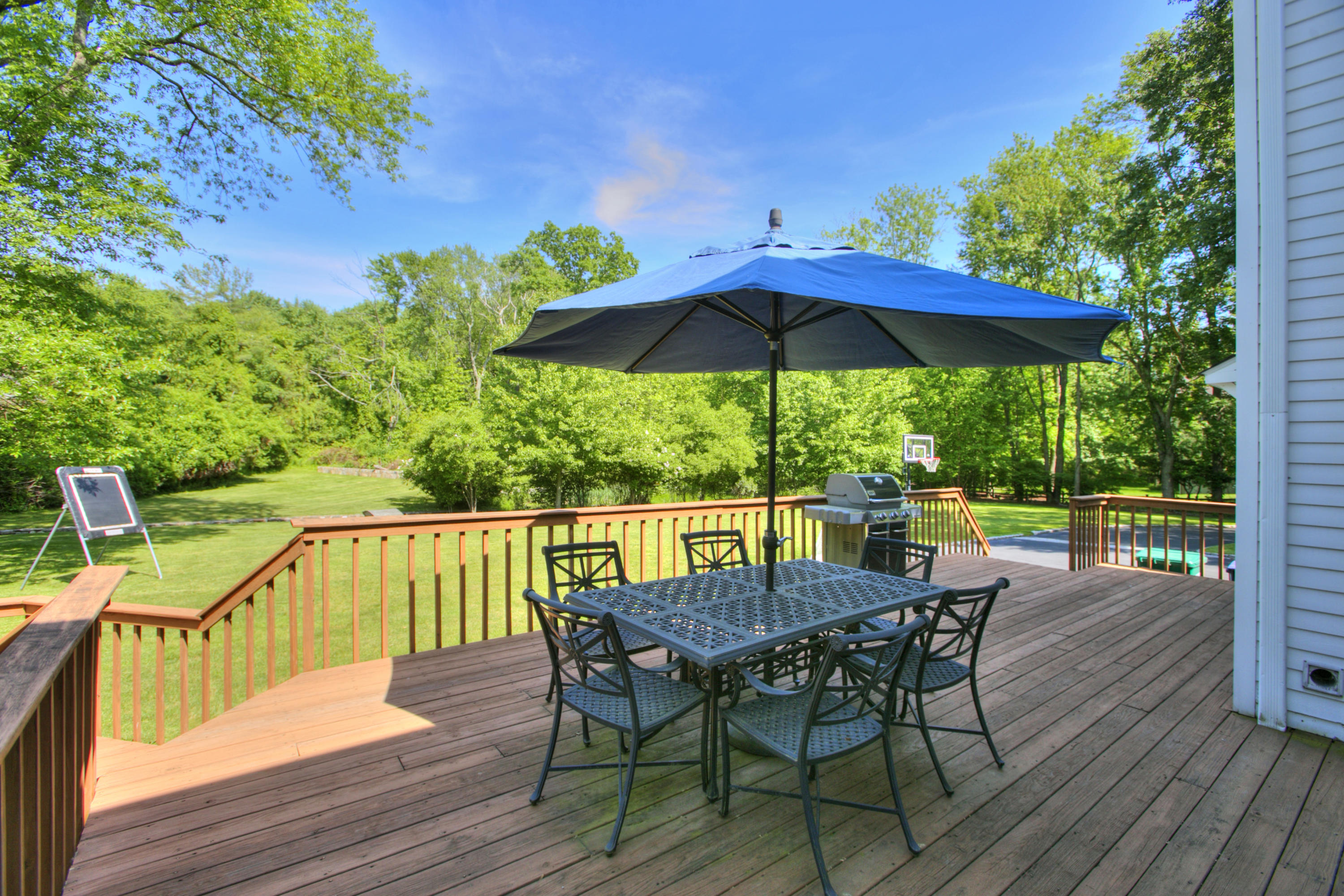 195 Ponus Ridge Road New Canaan, CT 06840 - Photo 24 of 28 a view of deck with furniture and umbrella