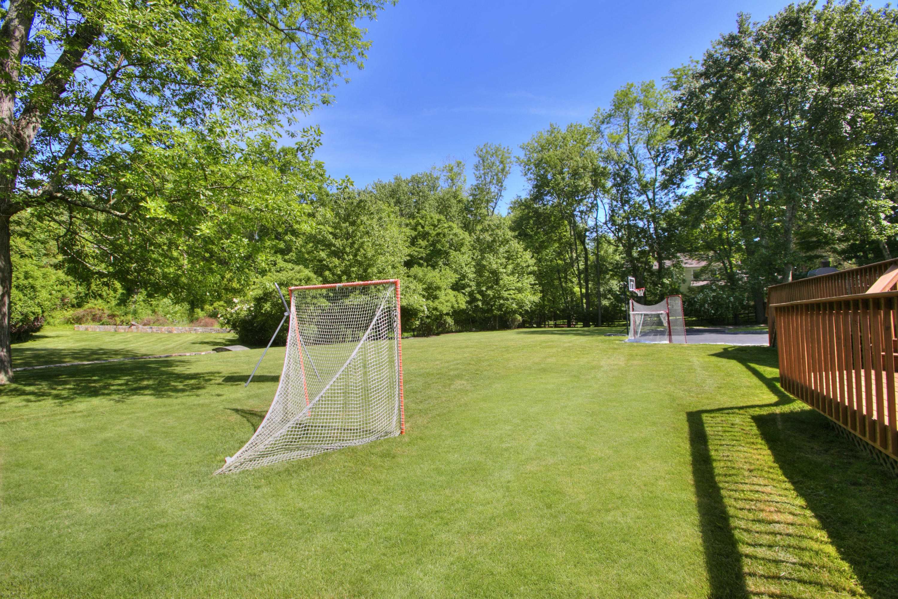 195 Ponus Ridge Road New Canaan, CT 06840 - Photo 25 of 28 a view of a backyard with basketball court