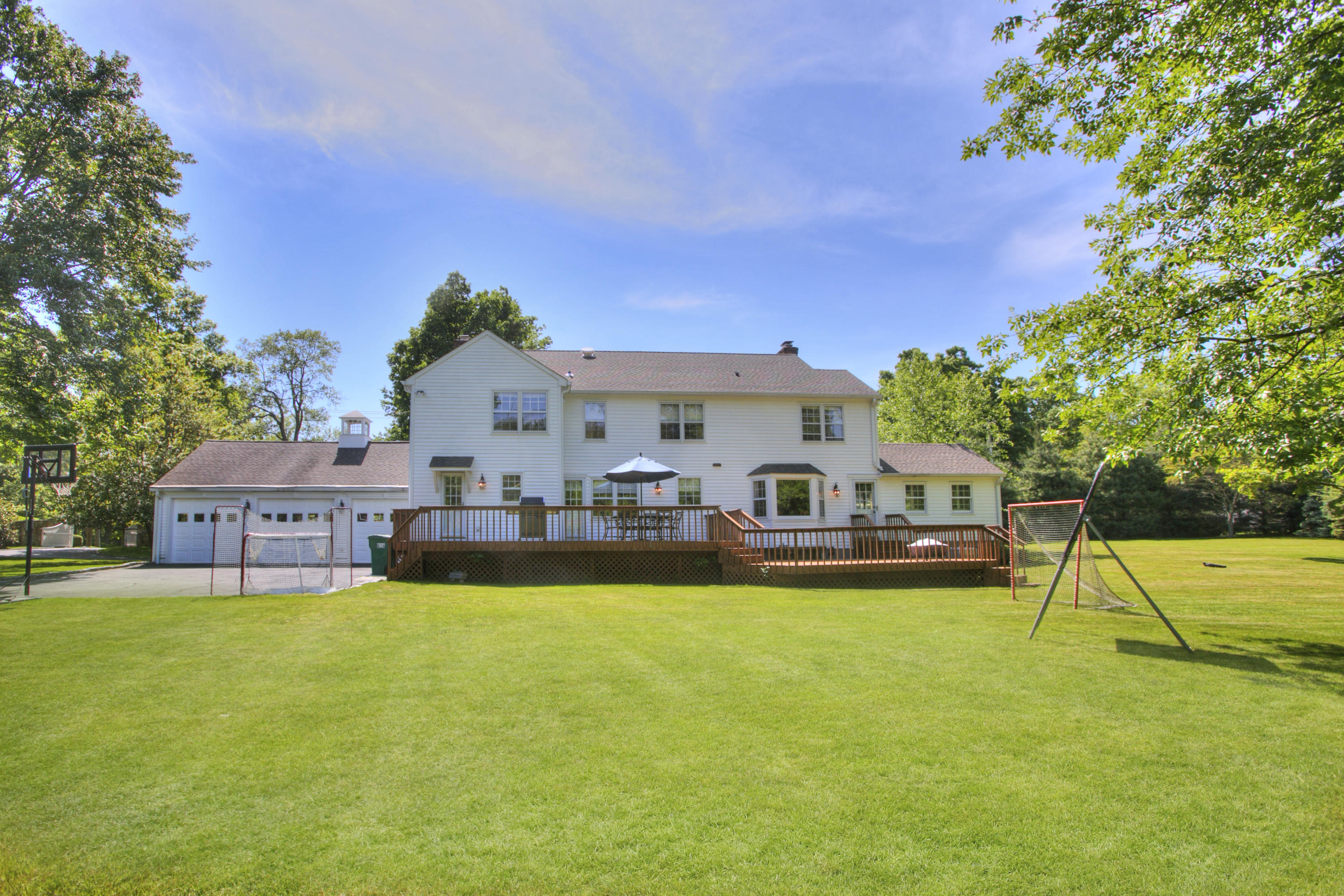195 Ponus Ridge Road New Canaan, CT 06840 - Photo 27 of 28 a view of a house with a big yard and sitting area
