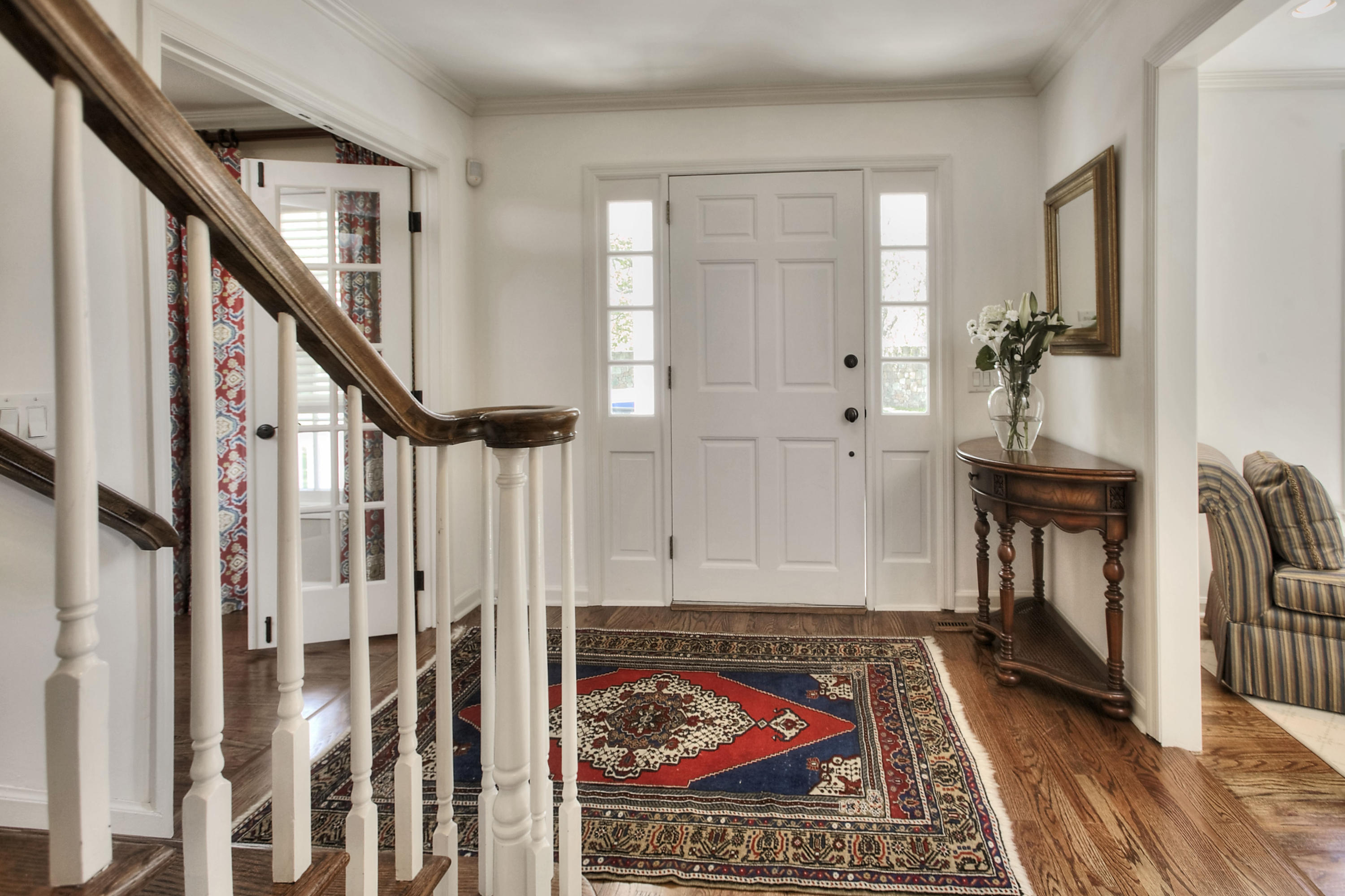 195 Ponus Ridge Road New Canaan, CT 06840 - Photo 3 of 28 a view of a hallway with wooden floor and staircase