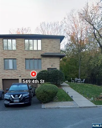 a view of a car parked in front of a house