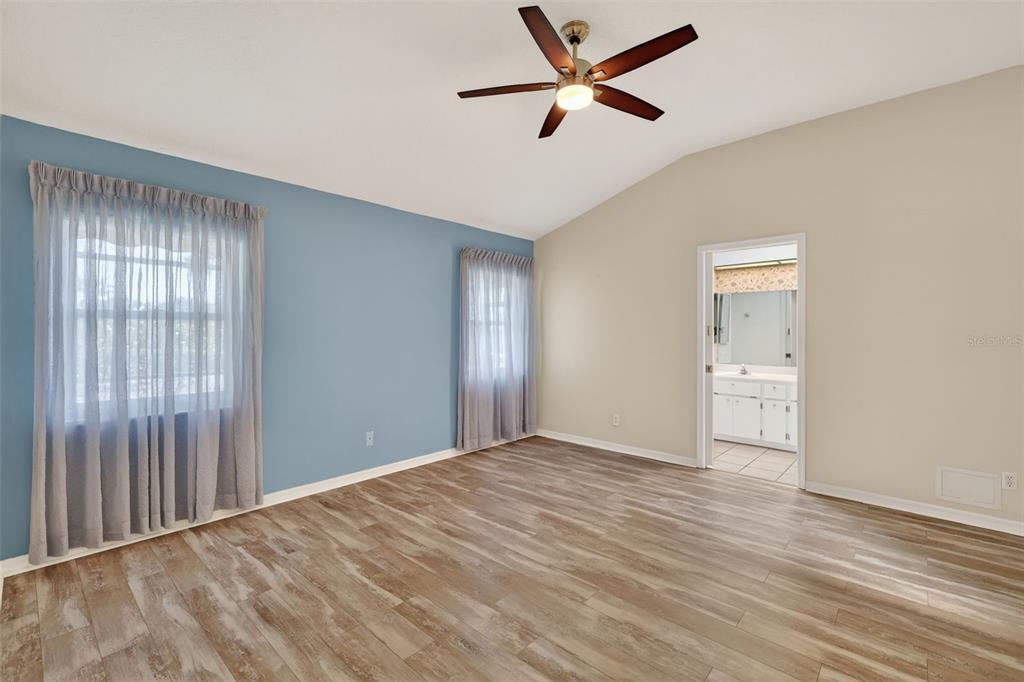 5500 Laver Street Leesburg, FL 34748 - Photo 14 of 35 a view of empty room with wooden floor and fan