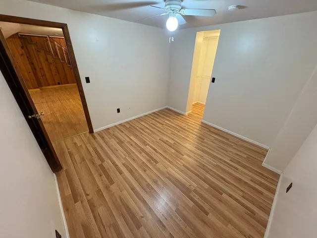a spacious bathroom with a sink a mirror and a shower