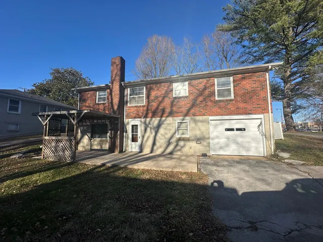a view of a backyard with large trees