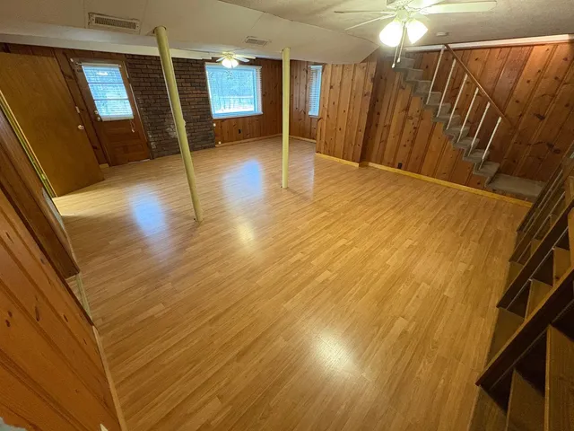 a view of a room with wooden floor