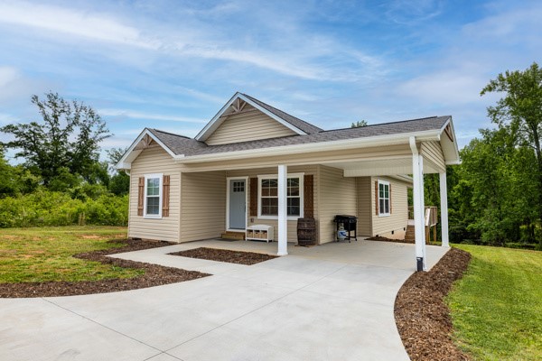 This charming home offers a serene escape with verdant surroundings and ample outdoor living space.