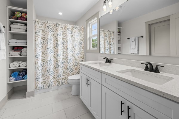 611 South Walnut Street Seneca, SC 29678 - Photo 13 of 31 This ensuite bathroom features a double vanity and sleek craftsman design.