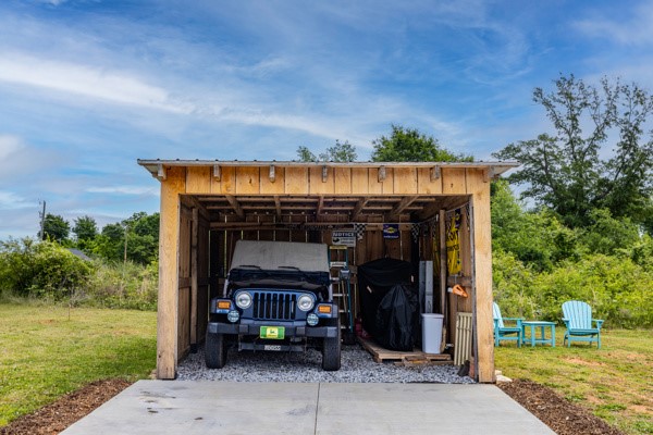 611 South Walnut Street Seneca, SC 29678 - Photo 21 of 31 This rustic carport/storage space offers practical outdoor storage, blending seamlessly with the natural surroundings.