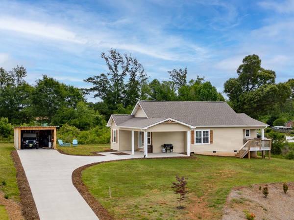 611 South Walnut Street Seneca, SC 29678 - Photo 25 of 31 This charming home features a convenient carport and a spacious deck, perfect for outdoor enjoyment.